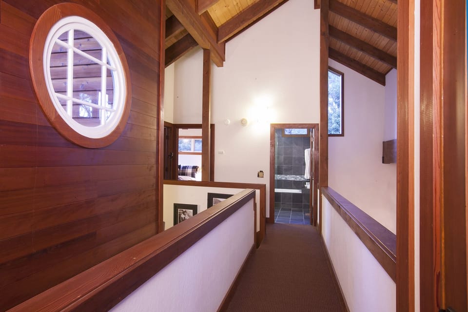 Cathedral ceiling, wood beams and paneling bring in the warmth of this luxury home. At the end of the hallway is a private entrance to the 2nd Master Ensuite bedroom. At the other end of the hallway is a full guest bathroom, a guest bedroom with a qu
