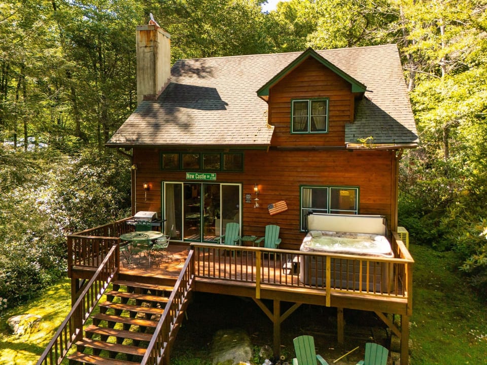Waterfall Cottage is tucked among the trees with a spacious deck, hot tub, and peaceful creekside setting