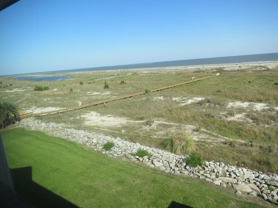 Boardwalk to sandy beach/ocean. View from deck.
