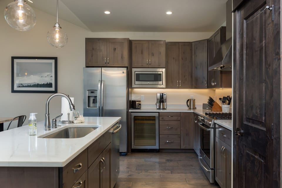 Kitchen has dedicated beverage fridge and high-end appliances.