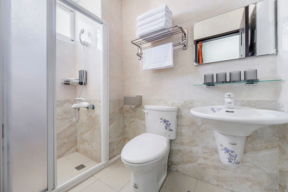 Shower, hair dryer, slippers, towels