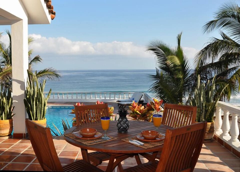 breakfast table overlooking pool and beach