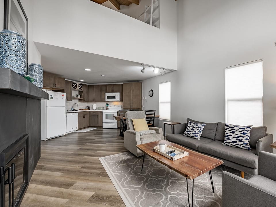 Spacious open-concept living room with modern kitchen access