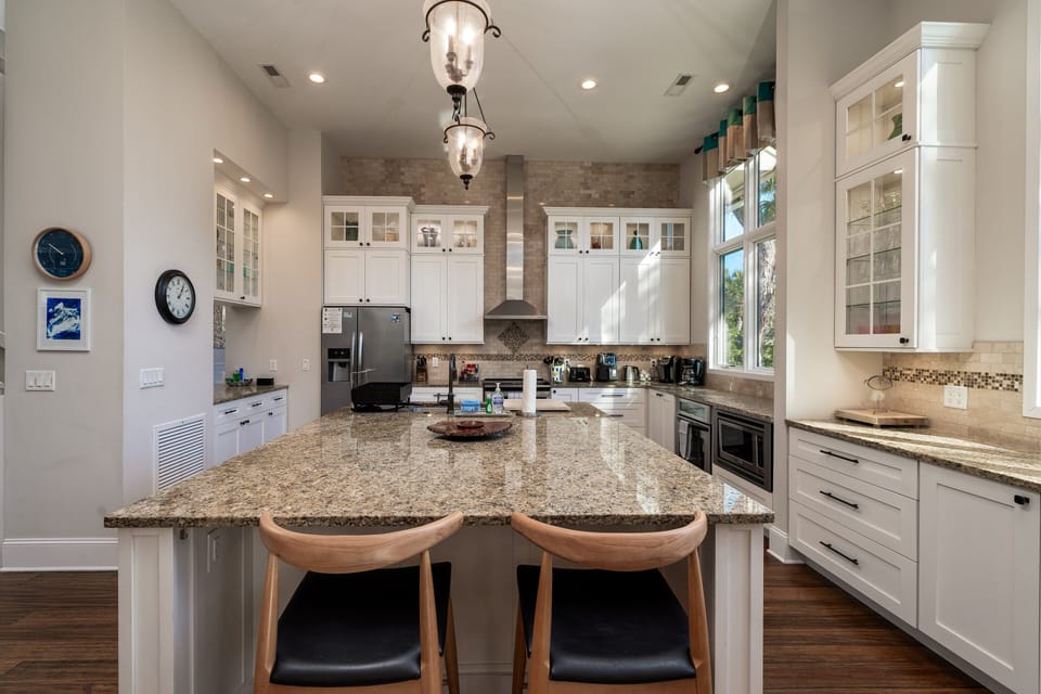 The large center island anchors the kitchen
