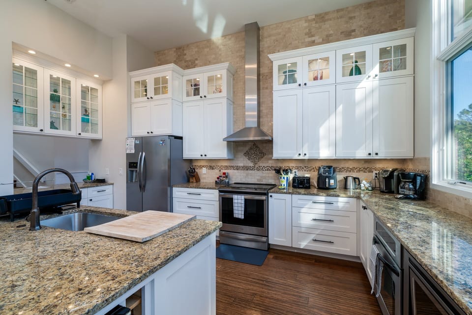 The stainless steel appliances include an oven, microwave, and dishwasher.