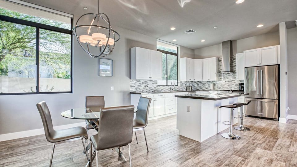 Bright kitchen with stainless appliances, island seating, and chic design