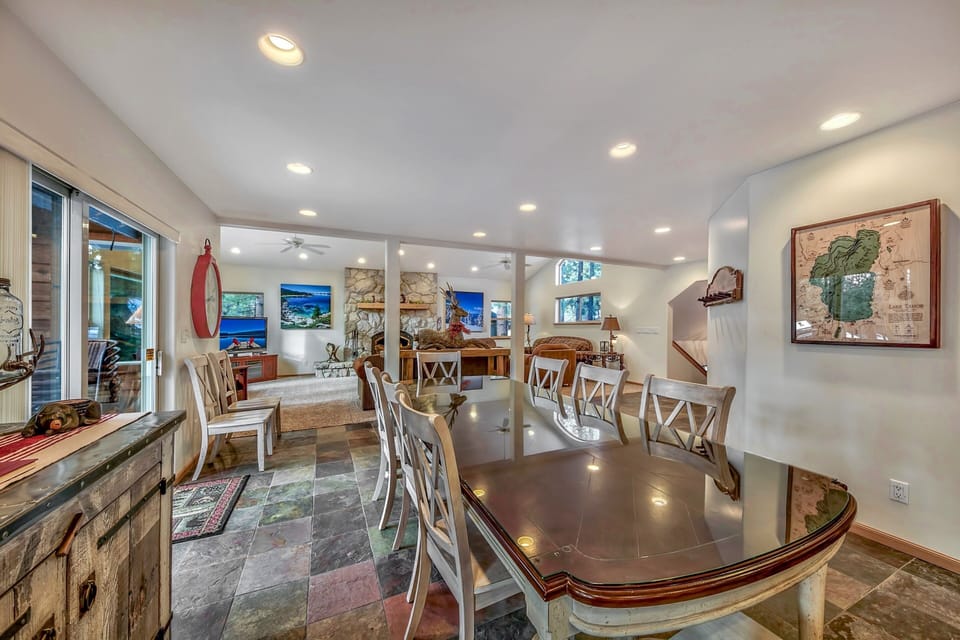 The dining table is located between the kitchen and living room and seats 8