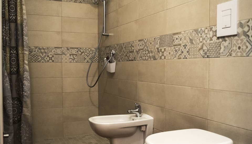 Classic Double Room, Ground Floor (Ciliegio) | Bathroom | Shower, hair dryer, bidet, towels
