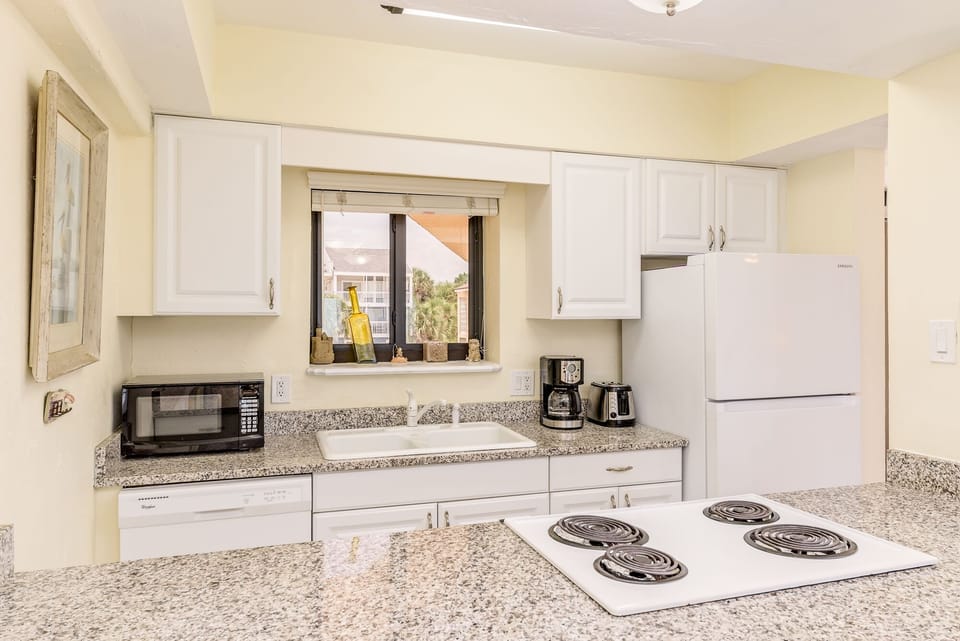 Fully -equipped kitchen with granite counter-tops