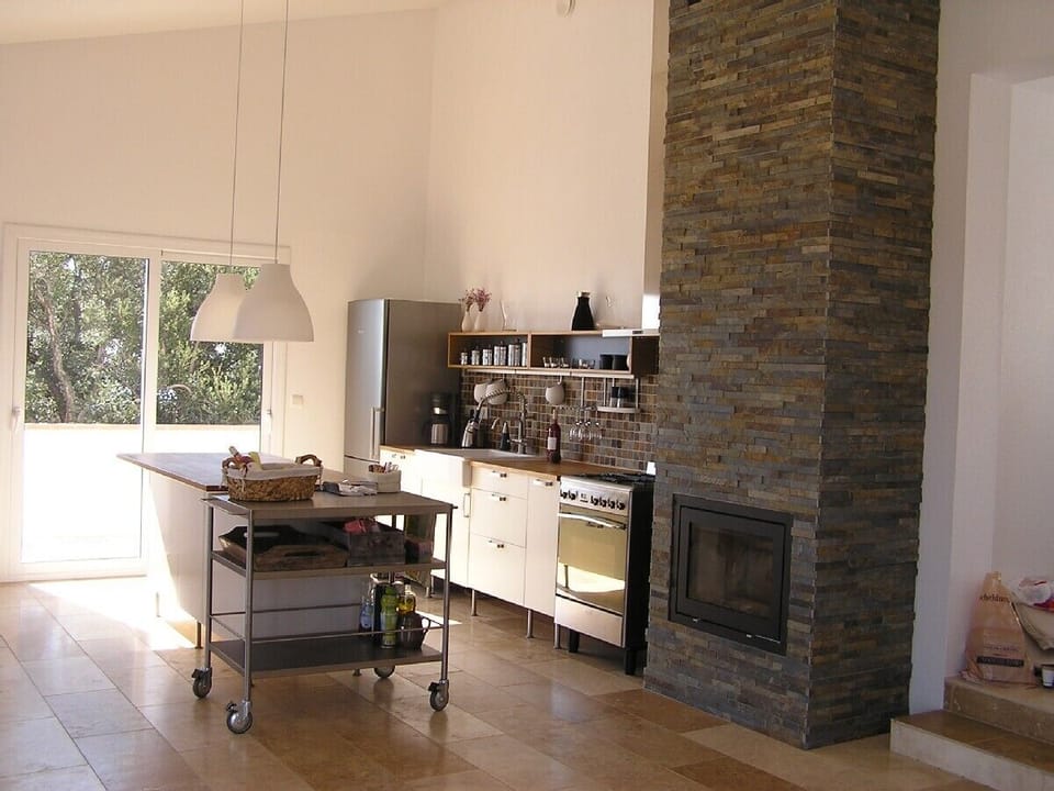 Kitchen area with high quality amenties and stone fire place