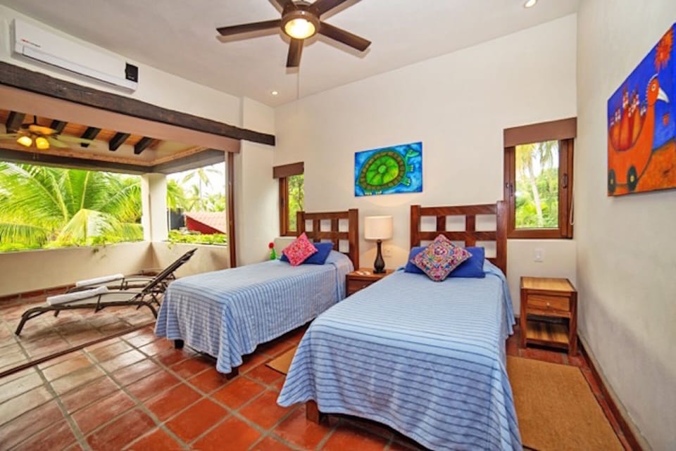2nd Story bedroom with 2 twin beds and attached patio