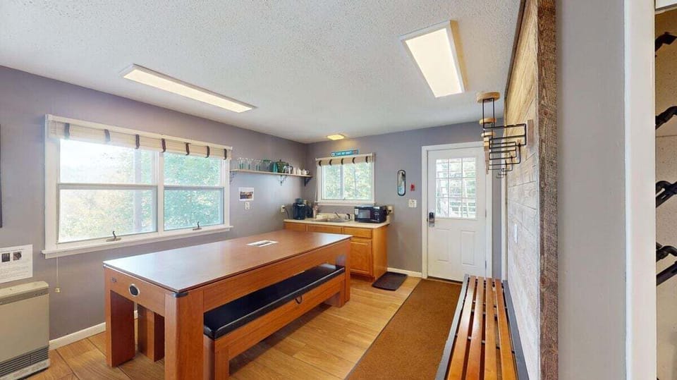 Lower level game table area with bench seating, ideal for cards and board games.