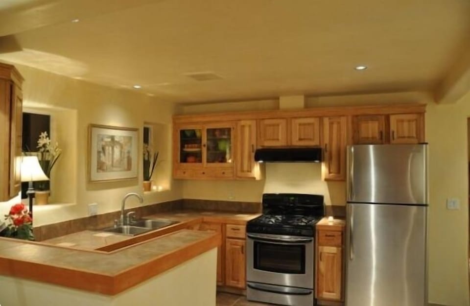 Kitchen with gas stove; pots, pans, and very nice dishes and serving pieces