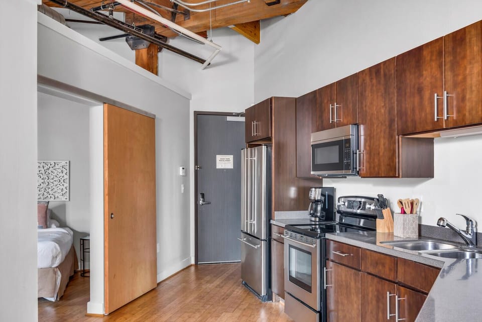Full kitchen with standard coffee maker with one of the bedrooms located off of the kitchen