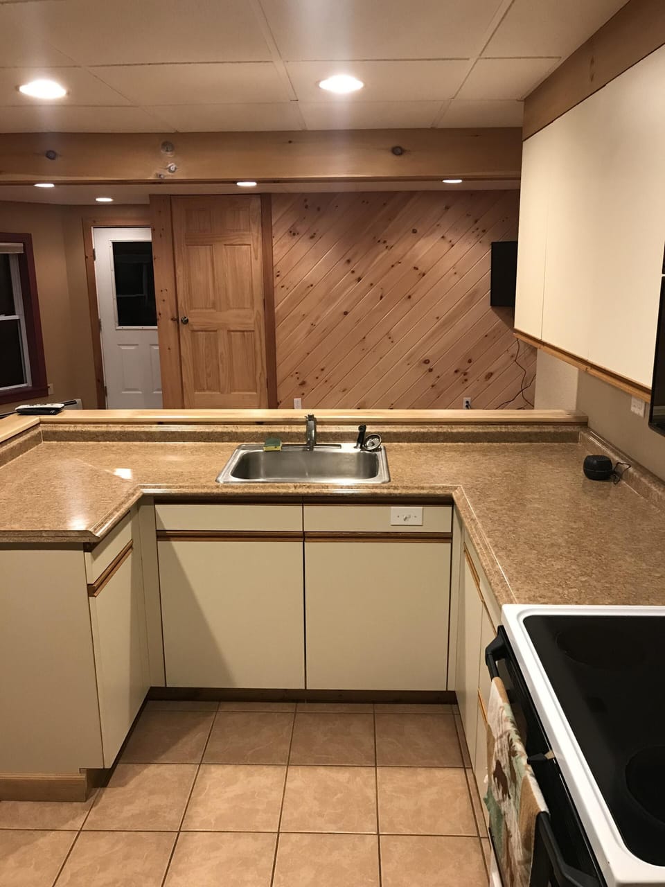 The kitchen with a stove, oven, fridge, dishwasher, coffee maker and toaster. 