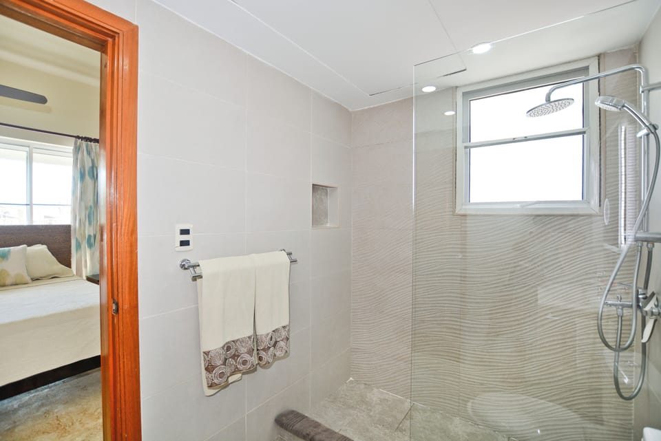 Spacious walk in shower with contemporary tile work and high end fixtures
