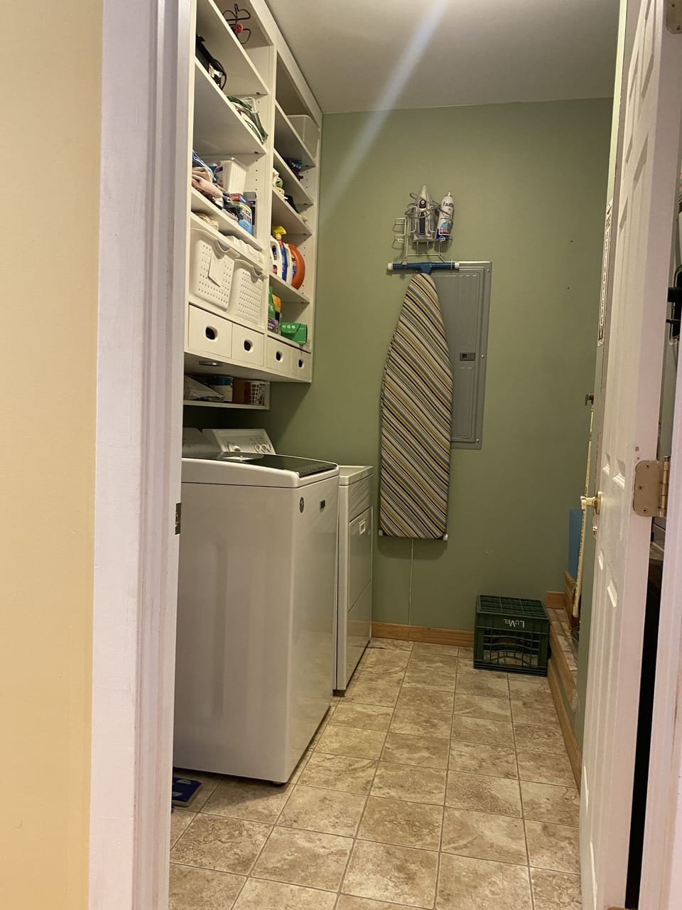 The laundry room stocked with extra sheets, and laundry necessities.