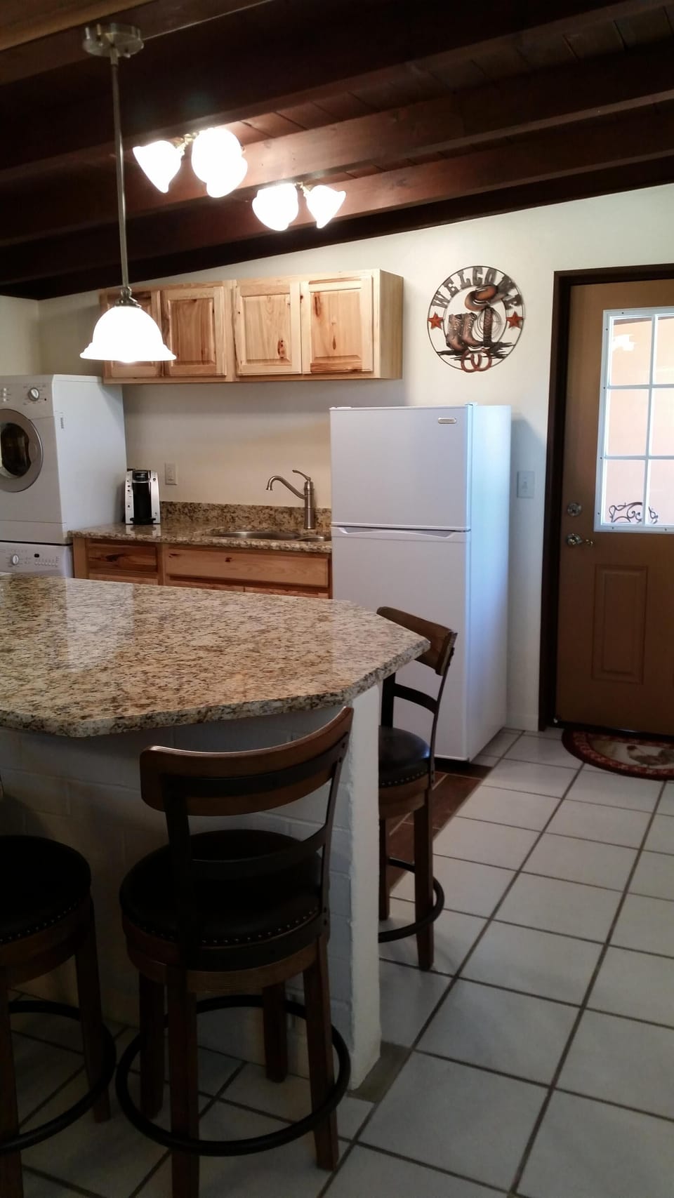 Kitchen with granite counters has seating for 4. 