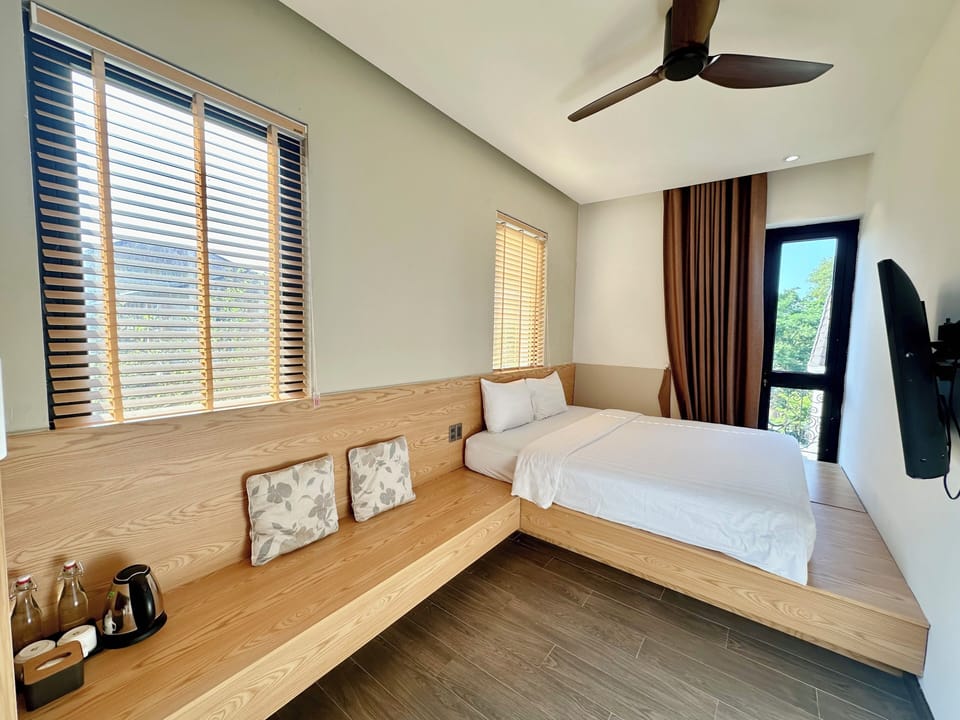 Premium bedding, desk, laptop workspace, blackout drapes