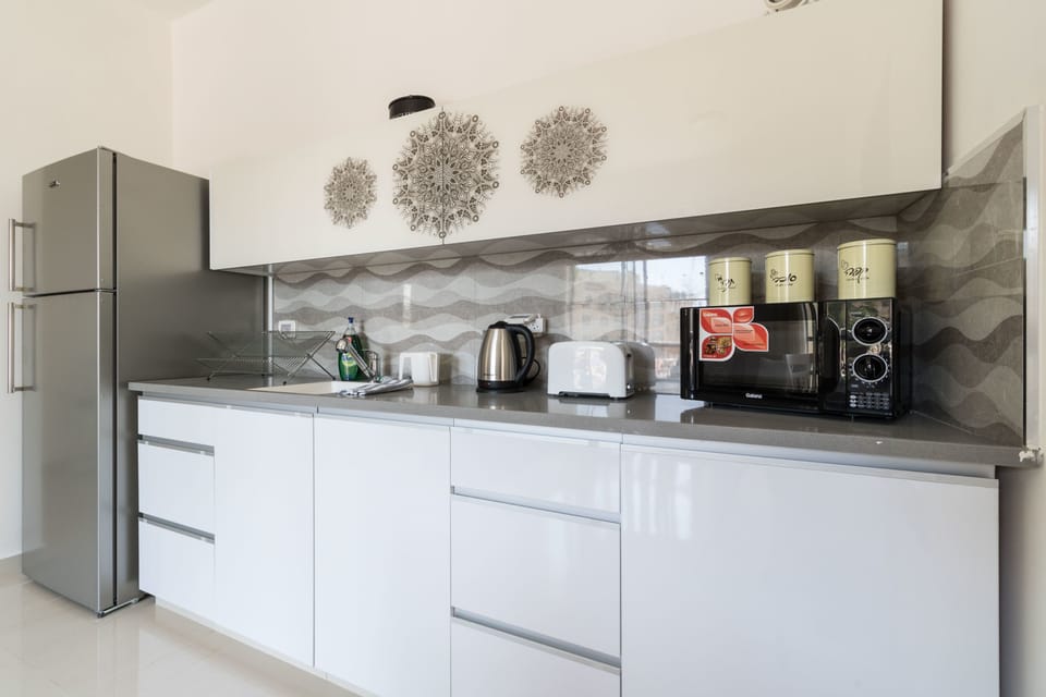 Comfort Apartment, 1 Bedroom | Private kitchen | Full-size fridge, microwave, stovetop, coffee/tea maker