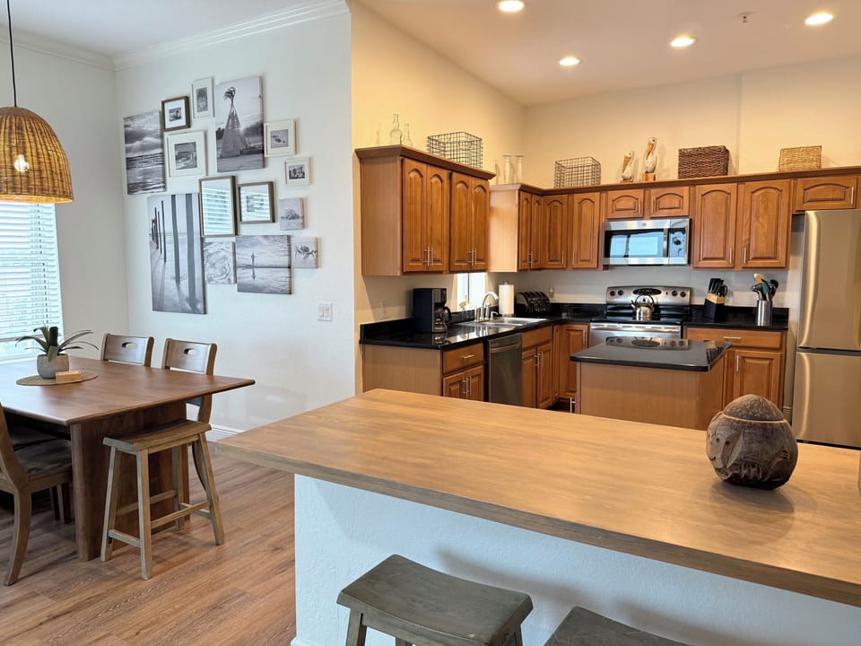 Spacious Kitchen with Stainless Steel Appliances and Bar Seating 
