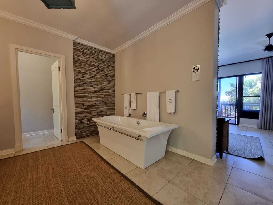 Premier Apartment | Bathroom | Deep soaking tub, hair dryer, towels