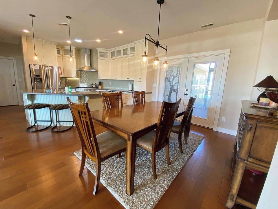 Spacious open-concept dining area flows into the white kitchen at Midnight Manor, perfect for group gatherings in Kanab, UT.