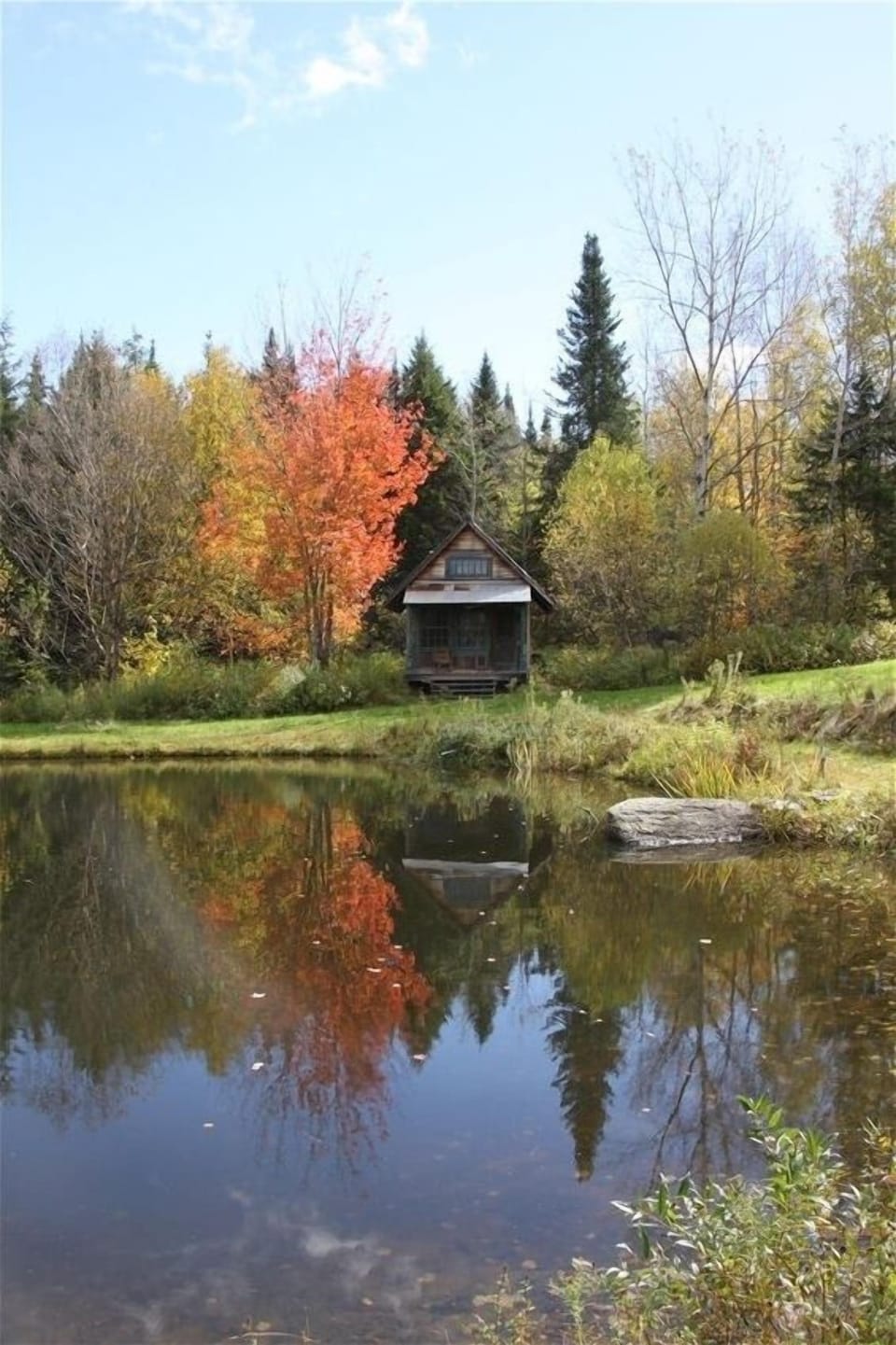 Looking across the swimming pond at our cozy cabin.