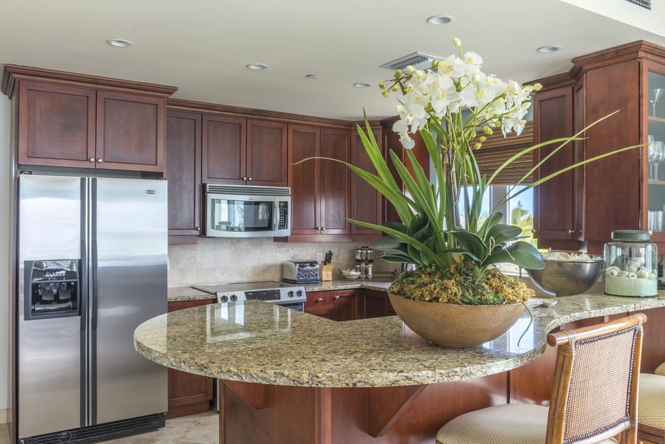 Full equipped kitchen with stainless steel appliances, granite countertops.