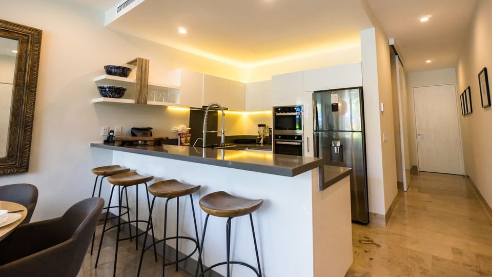 Deluxe Condo, Non Smoking | Private kitchen | Full-size fridge, microwave, oven, stovetop