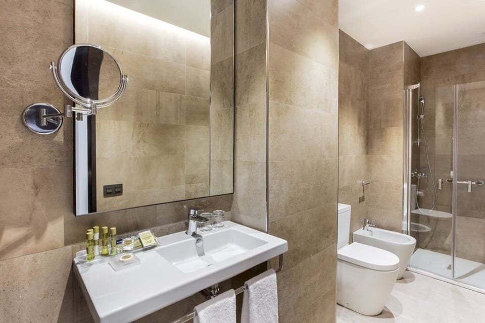 Deep soaking tub, rainfall showerhead, eco-friendly toiletries