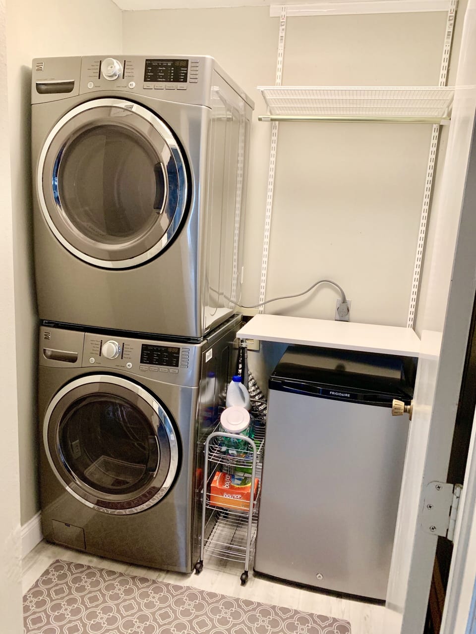 Kenmore HE washer/dryer with folding table & storage shelf with hanging bar