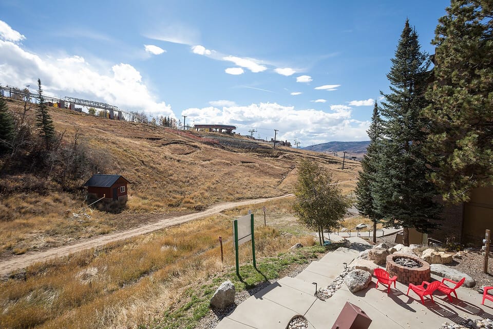 Mountain landscape with ski lift infrastructure visible on the slopes during off-season.