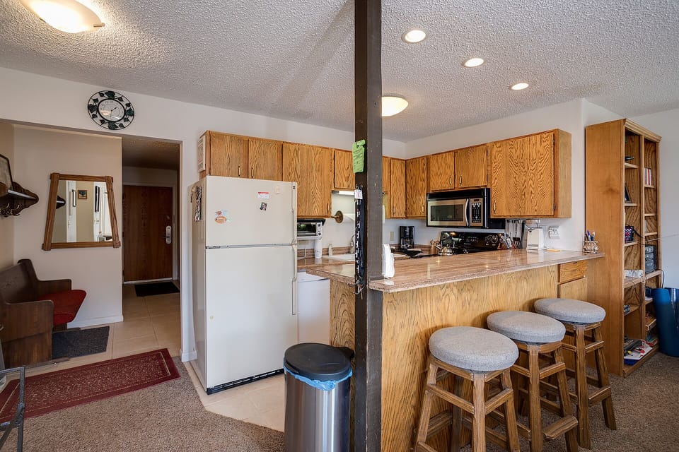 Your fully equipped kitchen welcomes you with warm wood cabinetry, granite countertops, and everything needed for home-cooked meals together.