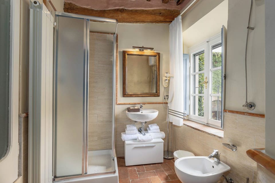 Deluxe Room, 1 Queen Bed | Bathroom | Shower, hair dryer, slippers, bidet