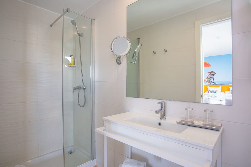 Shower, designer toiletries, hair dryer, towels