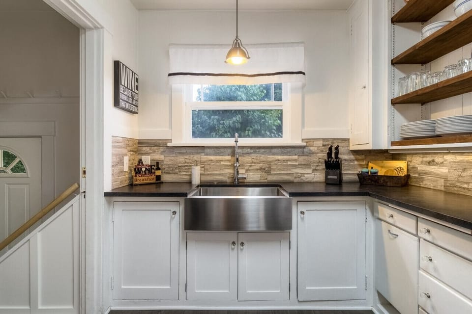 Kitchen complete with stainless steel sink and plenty of dinnerware