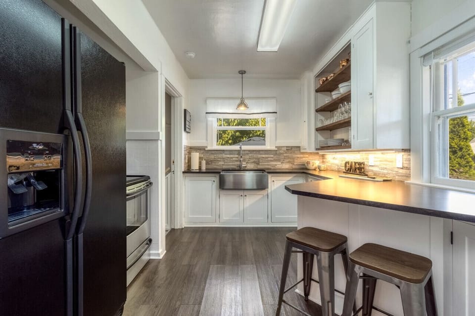 Kitchen complete with fridge and stainless steel oven