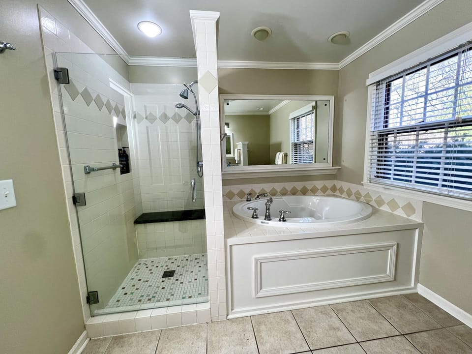 PRIMARY EN-SUITE BATHROOM: walk-in shower, huge soaking tub, granite surfaces 