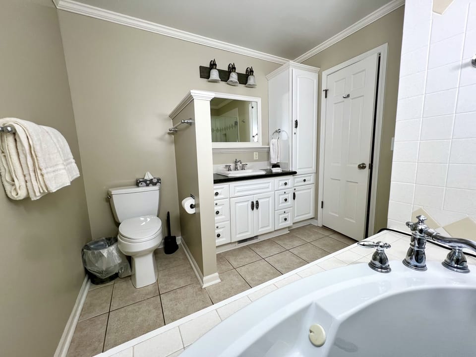 PRIMARY EN-SUITE BATHROOM: walk-in shower, huge soaking tub, granite surfaces 