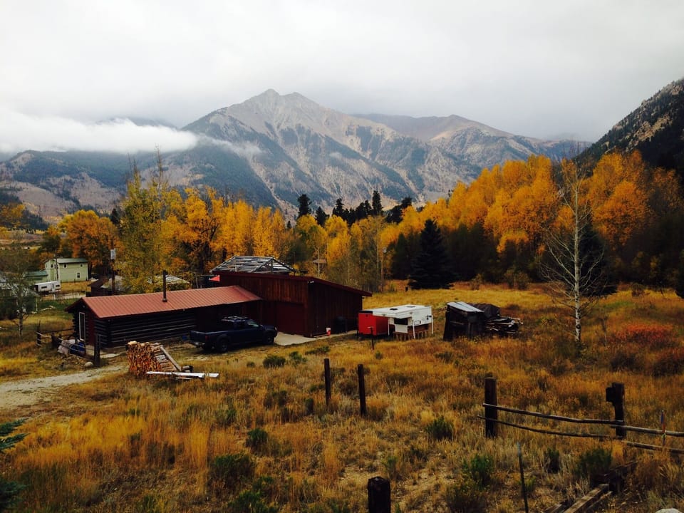 The cabin in the fall, looking down from the road above,