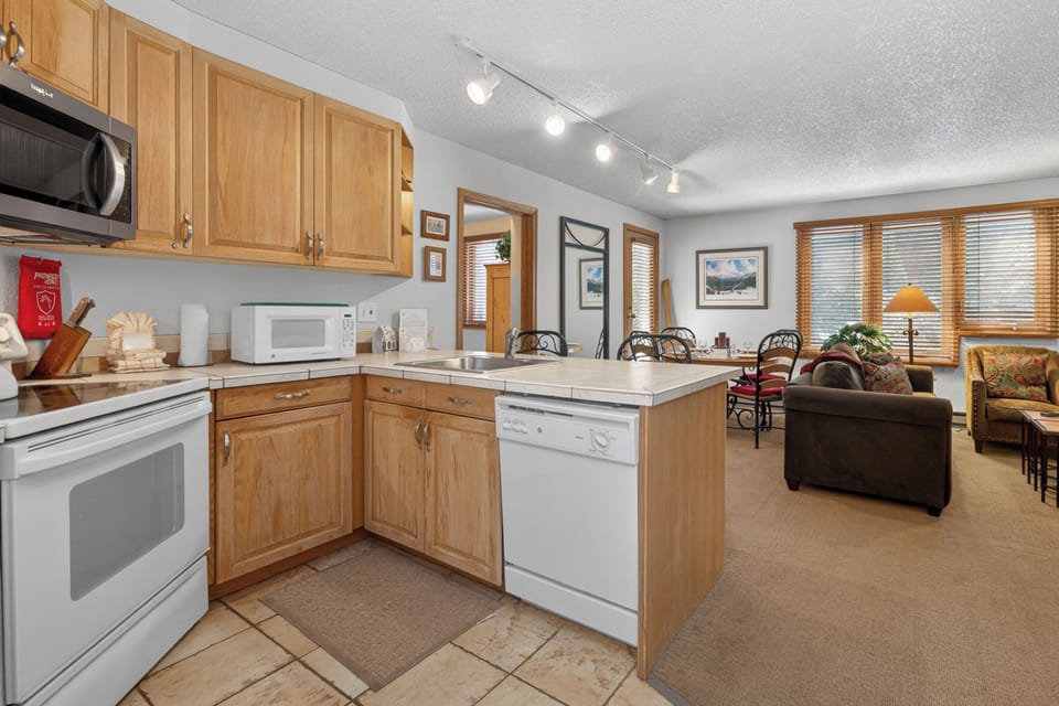 Step into your home base for adventure! This open-concept space blends a full kitchen with dining and lounge areas—perfect for cooking meals together and relaxing after mountain days.