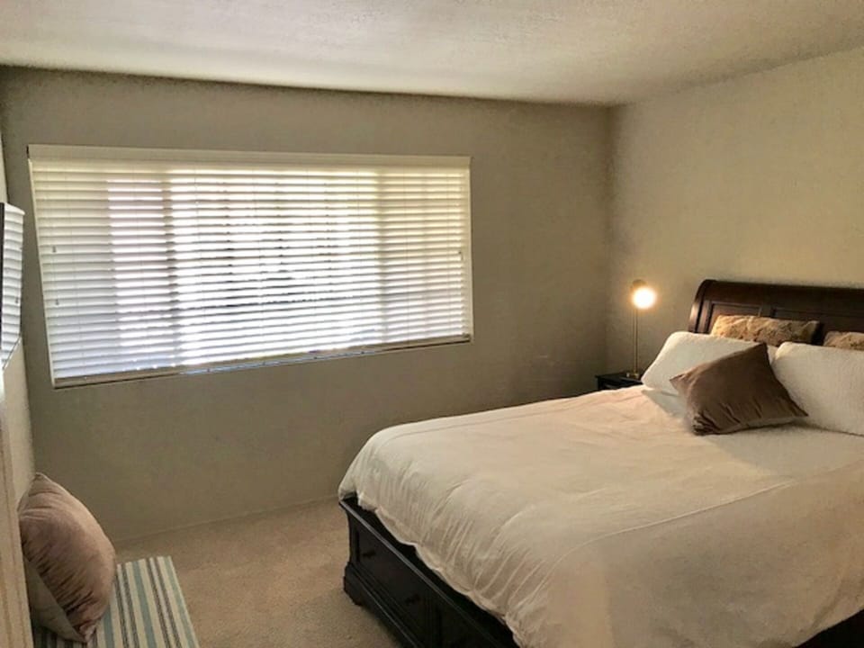 Guest room features queen size bed, tv.