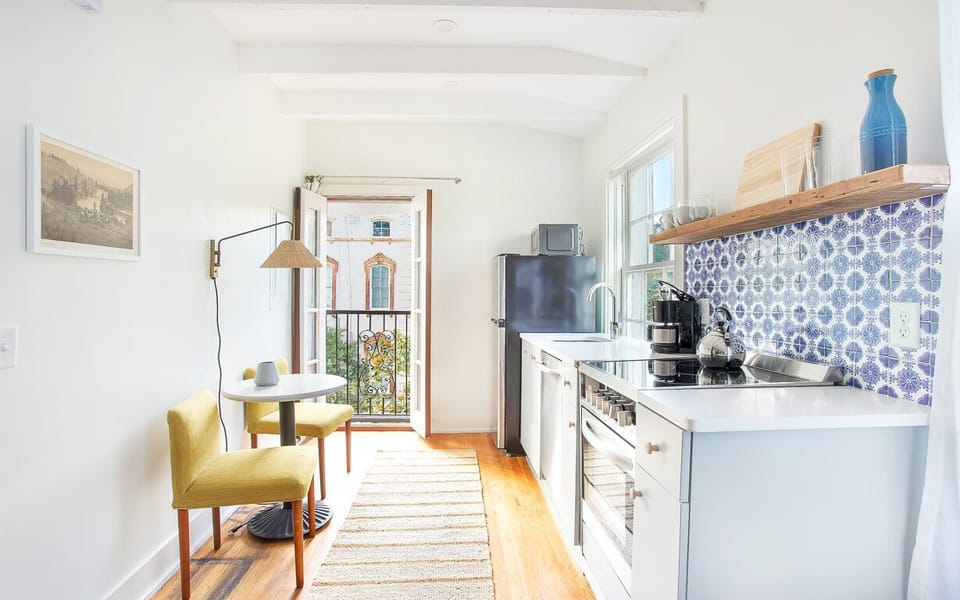 The full kitchen is adjacent to an eating nook for two.