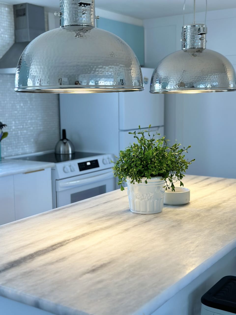 Hammered nickel island lights.