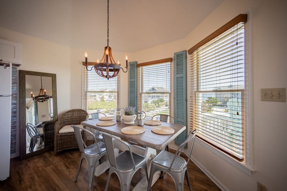 Dining table off the kitchen island with ocean views.