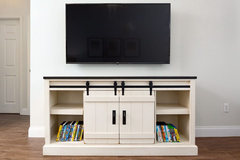 60 inch 4K TV in the living room with over 30 kid-friendly DVDs &Blu Ray Discs