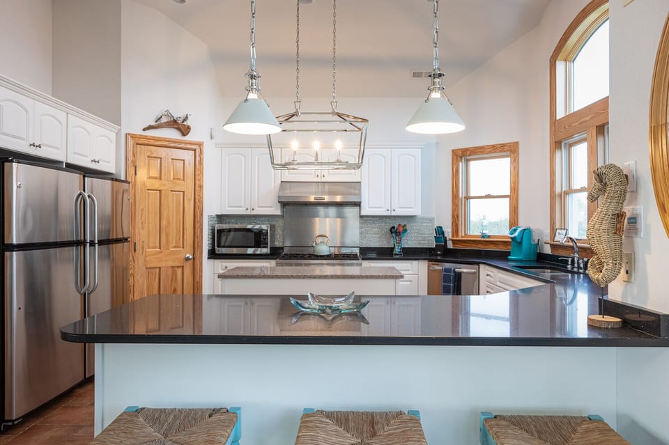 Bar seating, two dishwashers and two refrigerators and large gas stove.