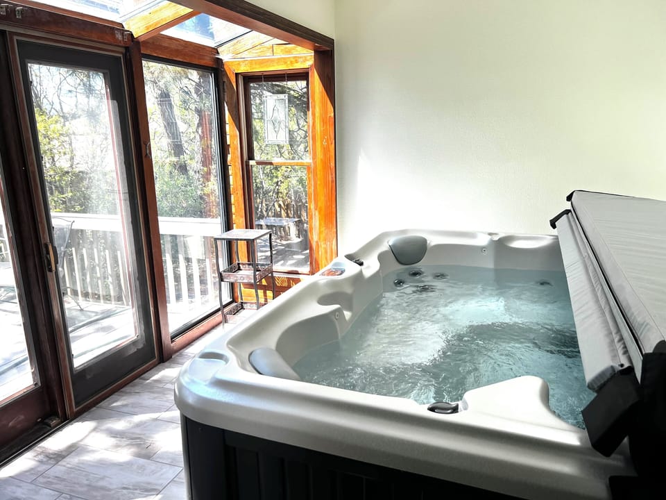 Indoor Hot tub with sunlights and wooded views. Seats 6-8