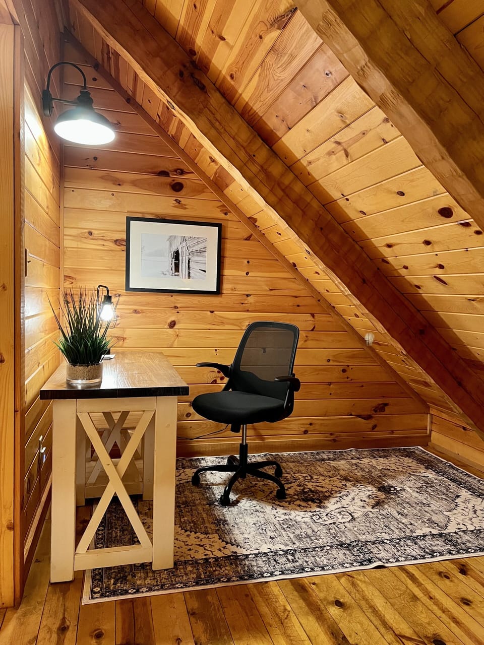 Cozy desk space in the loft with good lighting, USB ports.